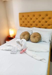 a bed with two slippers and a headboard and two towels at "Zen Spot" Saekyung Condo Unit in Lapu-Lapu City in Lapu Lapu City