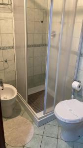 a bathroom with a shower and a toilet and a sink at Casa Borghellina in Montaione +11 photos