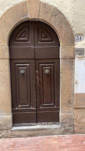 a large brown door in a stone building at Casa Borghellina in Montaione