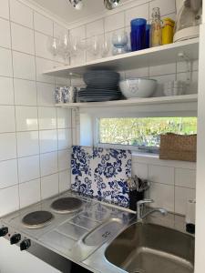 a kitchen with a sink and a counter top at Sommarvilan in Vaxholm