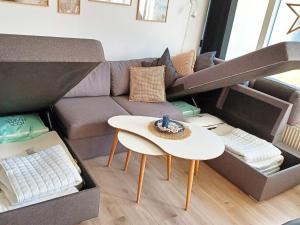 a living room with a couch and a table at 4 person holiday home in Ringkøbing-By Traum in Ringkøbing +55 photos
