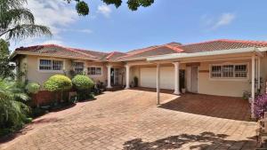 a house with a red roof and a brick driveway at 54 Asteria Ave, Larnaco Estate in Kingsburgh