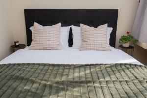 a bedroom with a large white bed with pillows at Studio in the center of Gabrovo in Gabrovo +13 photos