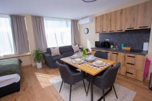 a kitchen and living room with a table and chairs at Studio in the center of Gabrovo in Gabrovo