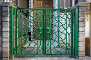 a green gate in front of a house at Premier suite Nishiazabu Roppongi front in Tokyo