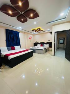 a bedroom with two beds and a ceiling at Coorg point in Madikeri