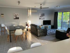a living room with a table and a dining room at Unit 9 Bellevue in Lakes Entrance
