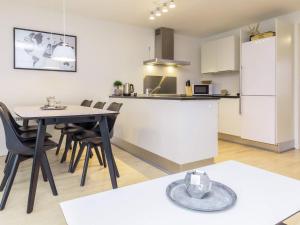 a kitchen and dining room with a table and chairs at 6 person holiday home in V ggerl se in Marielyst