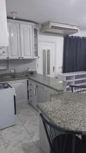 a kitchen with white cabinets and a granite counter top at شارع الخزان in Sharm El Sheikh