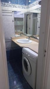 a bathroom with a sink and a washing machine at شارع الخزان in Sharm El Sheikh