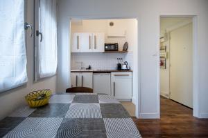 a small kitchen with a table in a room at Lovely studio near the Old Port in Marseille