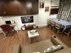 a living room with a couch and a dining room table at CEOZ1 Duplex 1BR Suite #Disneys HS #USM #SPICE in Bayan Lepas