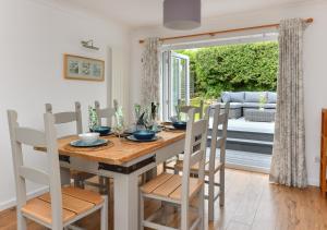 a kitchen and dining room with a table and chairs at Llys Neigwl in Abersoch