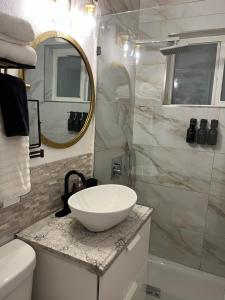 a bathroom with a white sink and a mirror at Stunning Little Havana Suites Close to Calle Ocho, Brickell and Wynwood and 10 mins to the Beaches - Free Parking in Miami