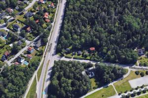 an overhead view of a road with houses and trees at 2 Bedrooms apartment in a villa, close to nature. in Västerås