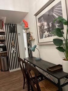 a dining room table with chairs and a plant at Stunning Little Havana Suites Close to Calle Ocho, Brickell and Wynwood and 10 mins to the Beaches - Free Parking in Miami