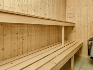 a wooden bench in a sauna at 8 person holiday home in V ggerl se in Marielyst