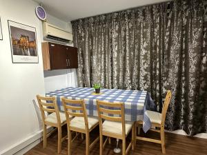 a dining room table with a blue and white checkered table and chairs at CEOZ2 6Pax Duplex 2BR Suite #Airport #USM #SPICE #Pantai in Bayan Lepas