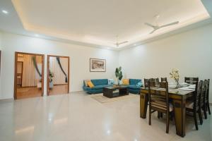 a living room with a table and a blue couch at Silver Leaf Apartments in Amritsar