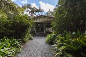 a house with a pathway leading to the front door at Rosella's On Springbrook in Springbrook
