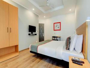 A bed or beds in a room at HOTEL CHETRAM ELITE near railway station