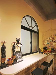 a window in a room with a table and chairs at sea monkey diving homestay in Green Island