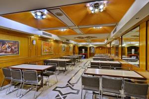 een rij tafels en stoelen in een restaurant bij OYO Hotel Kohinoor in Jaipur
