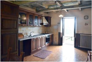 a kitchen with a sink and a stove at Casale La Fabbrica in San Romano