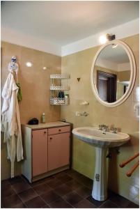 a bathroom with a sink and a mirror at Casale La Fabbrica in San Romano