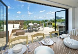 a dining room with a view of a patio at Morannedd in Abersoch