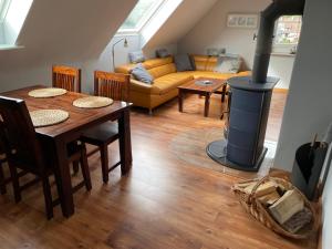 ein Wohnzimmer mit einem Tisch und einem Holzofen in der Unterkunft Ferienwohnung Durchholz in Steinhude