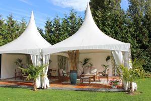 a white tent with chairs and tables in a yard at Clos De La Vaupalière - Rouen in La Vaupalière