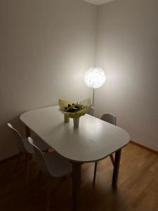 a white table with a bowl of fruit on it at Zurich 2 Bedrooms Apartment in Zürich