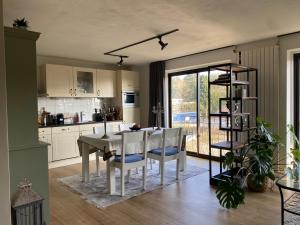 a kitchen with a table and chairs and a dining room at Luxe Appartement Marc in Arnhem