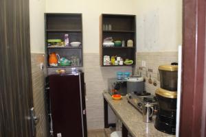 y cocina con nevera y fogones. en Atithi home stay, en Rāmnagar