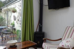 a living room with a stove and a green curtain at The Weaver's Cottage in Dungannon