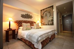 a bedroom with a large bed in a room at 702 Canal Quays in Cape Town +43 photos