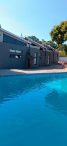 a house with a swimming pool in front of it at Mulala Luxury Guesthouse in Thohoyandou