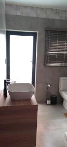 a bathroom with a tub and a sink and a toilet at Mulala Luxury Guesthouse in Thohoyandou