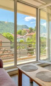 a living room with a large window with a view at Central Premium Apartment in Braşov