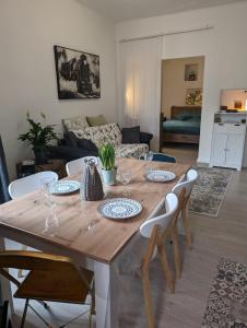 a dining room table with chairs and a living room at 2 pièces , Centre ville , 100 mètres des plages. in Menton