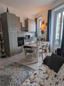 a kitchen and living room with a table and chairs at 2 pièces , Centre ville , 100 mètres des plages. in Menton