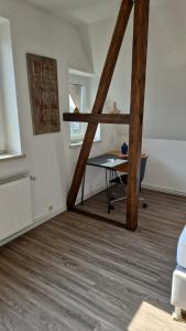 a room with a desk and a table in a room at Schillerstrasse in Burgstaedt