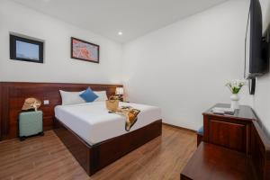 Postel nebo postele na pokoji v ubytování Sea Near Me Hotel Danang