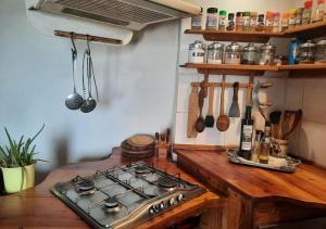 a kitchen with a stove and a wooden counter top at Casa Vacanze Paradise in Roccastrada