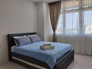 Postel nebo postele na pokoji v ubytování Business Getaways Suite 3 pa @ Riverine Kuching + 5 fotografií