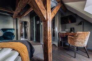 a bedroom with a bed and a desk and chair at Boutique Hotel Spedition a member of DESIGN HOTELS in Thun