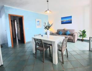 a living room with a white table and chairs at Fronte Mare in Torre San Giovanni Ugento