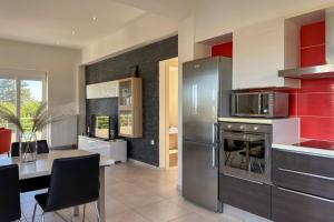 a kitchen with a stainless steel refrigerator and a table at Villa Adam in Chania Town