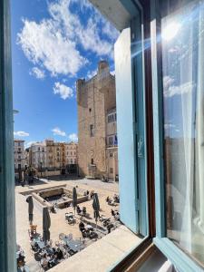 a view from a window of a courtyard with a castle at Domus Via Domitia in Narbonne